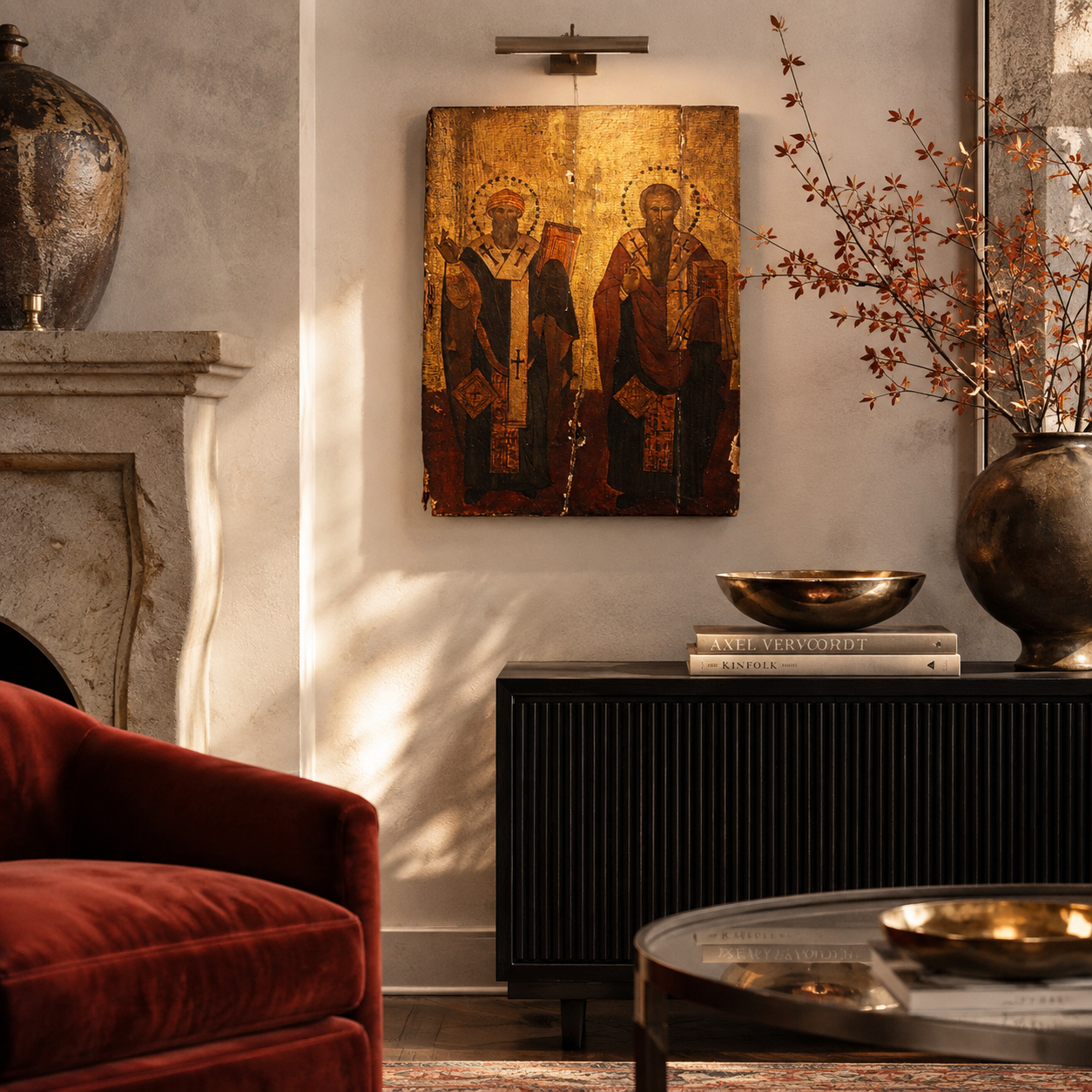 Dark fluted sideboard cabinet in matte black finish, styled with brass bowl, Axel Vervoordt and Kinfolk books, and large bronze vase with autumn branches.
