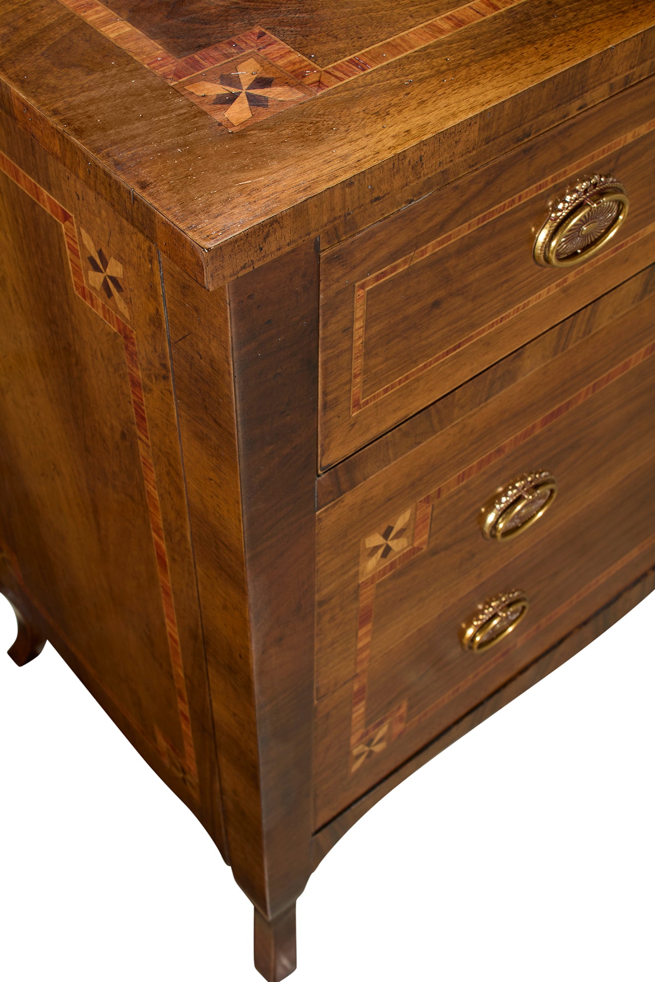 Brown wooden chest of drawers with decorative star inlay patterns, brass oval handles, and tapered legs. Features rich wood grain with contrasting light and dark wood borders.