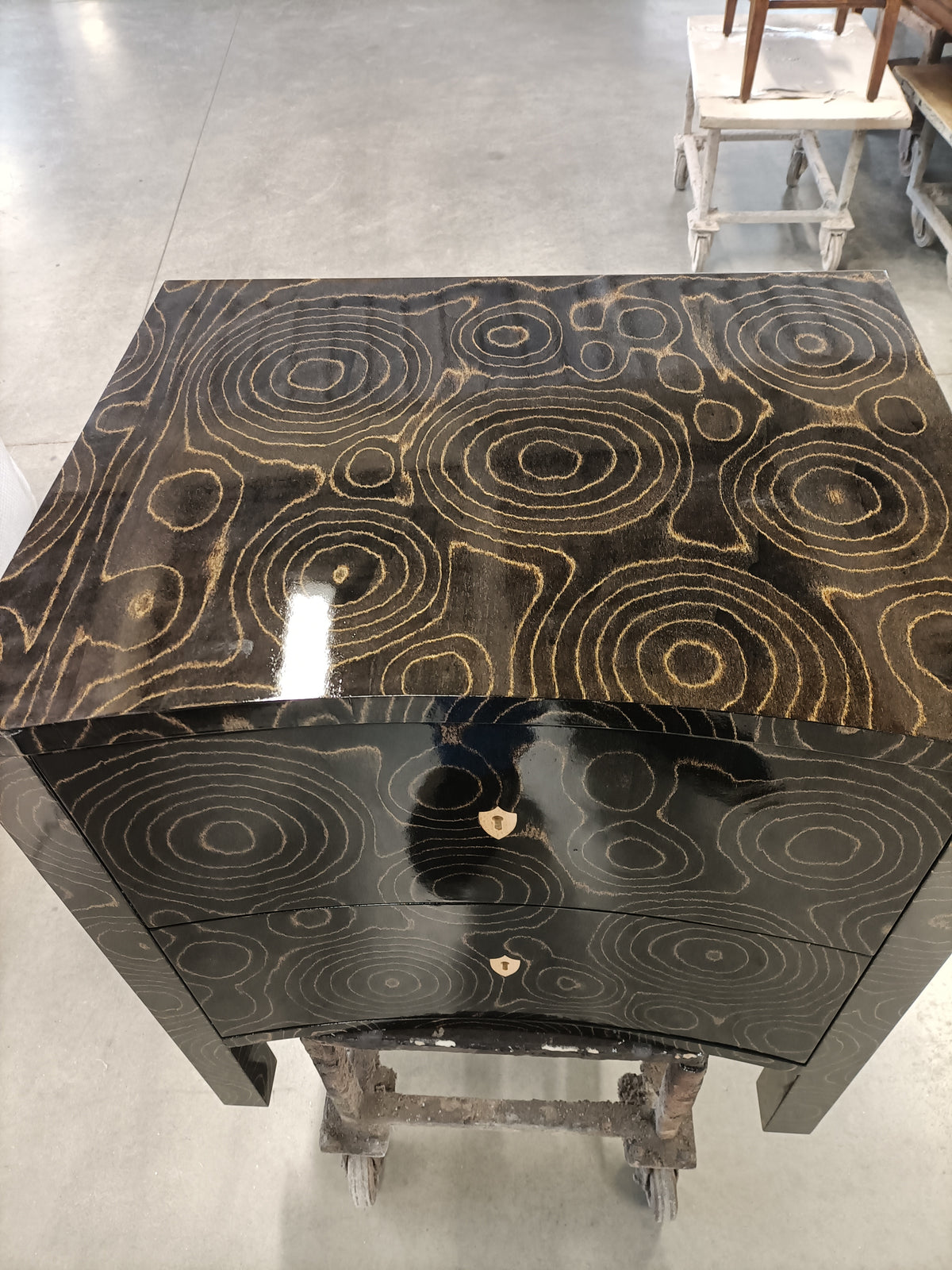 Black lacquered chest BRS9907SB with two drawers featuring intricate gold concentric circle inlay pattern, high-gloss finish, and small brass keyhole hardware.