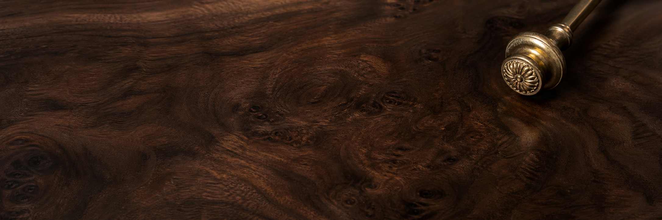 Close view of a hand-finished Italian burled wood surface