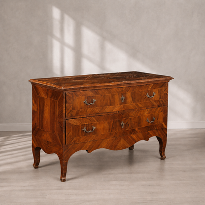Antique Italian-style walnut commode with two drawers, herringbone parquetry veneer, ornate brass bail handles, serpentine apron, and elegant cabriole legs in warm honey-brown tones.