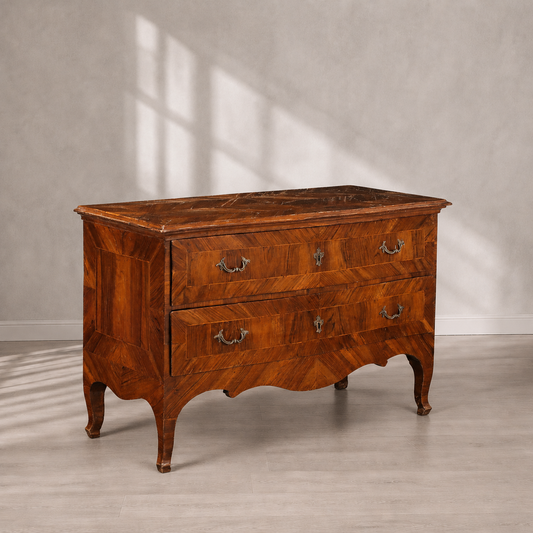 Antique Italian-style walnut commode with two drawers, herringbone parquetry veneer, ornate brass bail handles, serpentine apron, and elegant cabriole legs in warm honey-brown tones.