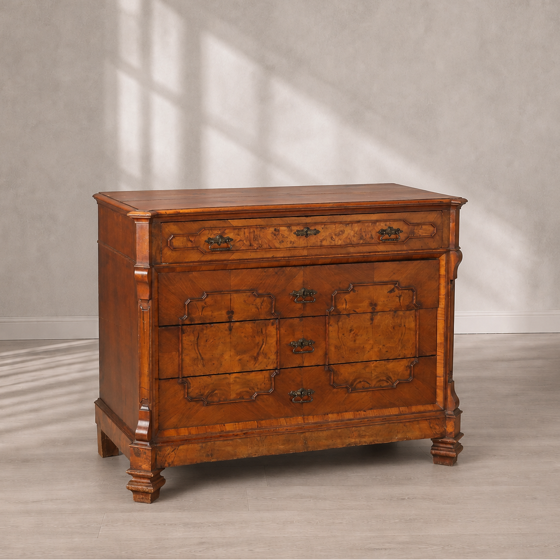 Antique walnut chest of drawers with burled wood veneer panels, ornate brass hardware, carved column corners, and bracket feet in warm honey-brown tones