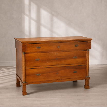 Antique-style cherry wood chest of drawers with three drawers, oval brass hardware pulls, keyhole escutcheons, column pilasters, and square tapered legs.
