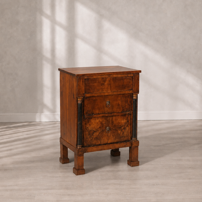 Antique-style walnut chest of drawers with three drawers, ebonized column accents with gilded capitals, lion ring brass hardware, and square tapered feet.