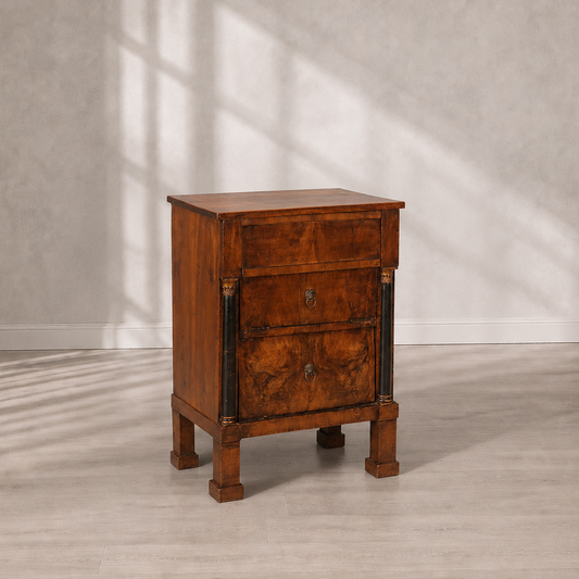 Antique-style walnut chest of drawers with three drawers, ebonized column accents with gilded capitals, lion ring brass hardware, and square tapered feet.