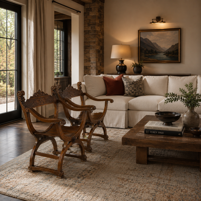 Pair of ornate antique Savonarola X-frame armchairs with intricate carved dark walnut wood scrollwork and curved saber legs, Renaissance Italian style