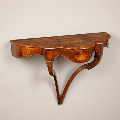 Antique demilune wall-mounted console table in warm walnut with marquetry inlay, serpentine apron, cabriole-style legs, and scenic landscape medallion on top.