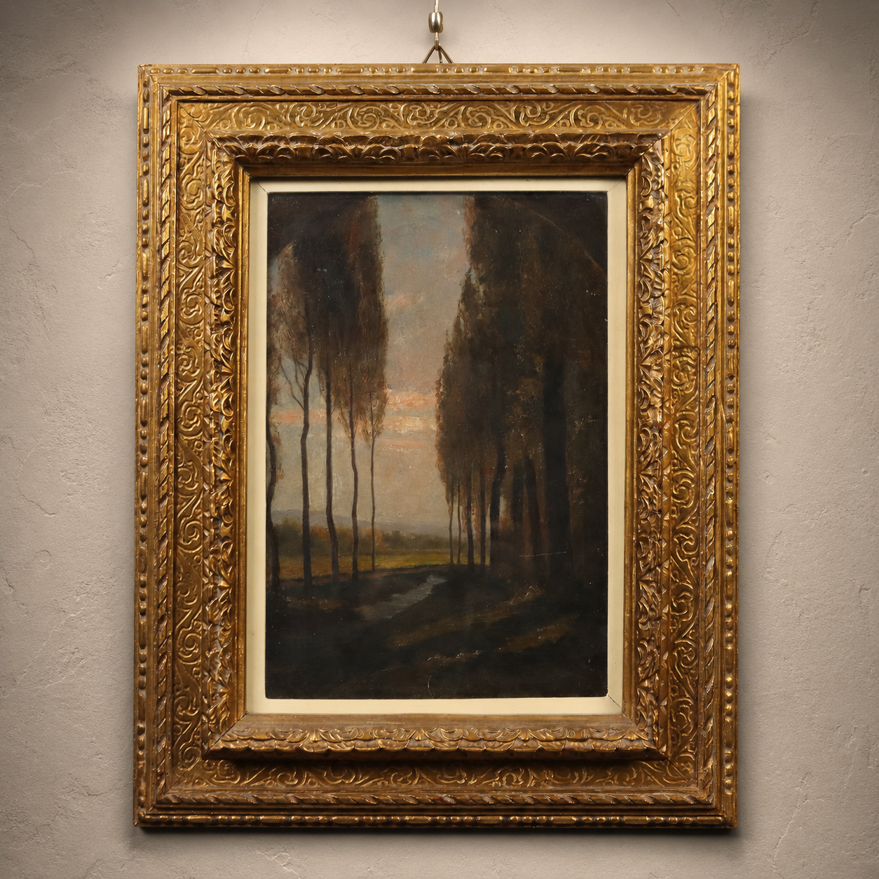 Antique oil painting in ornate gold gilt frame depicting tall poplar trees at dusk with warm sunset sky, dark moody landscape, intricate carved scrollwork border.