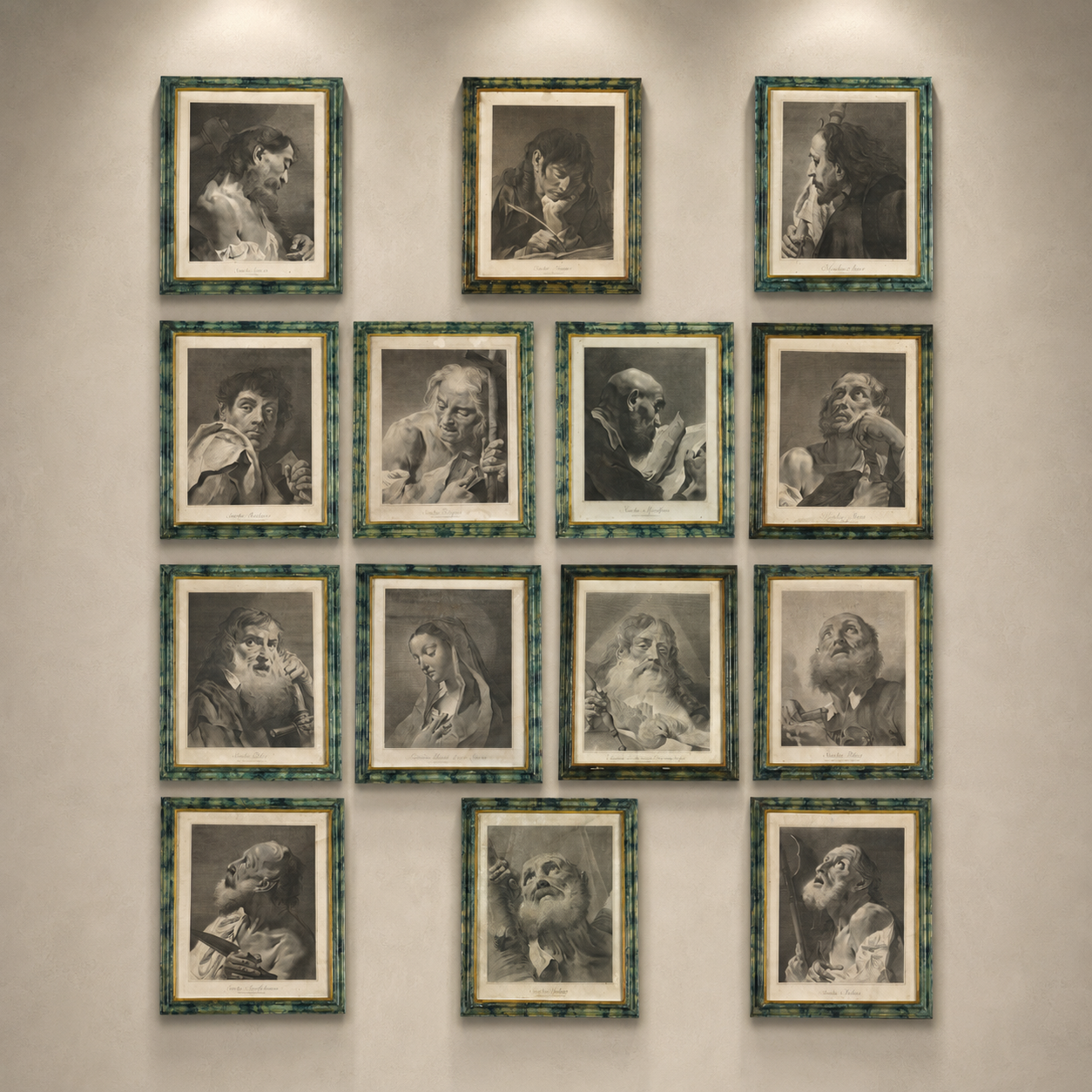 Set of 13 framed antique-style portrait prints in green tortoiseshell frames, monochrome engravings of classical figures, gallery wall arrangement on neutral wall