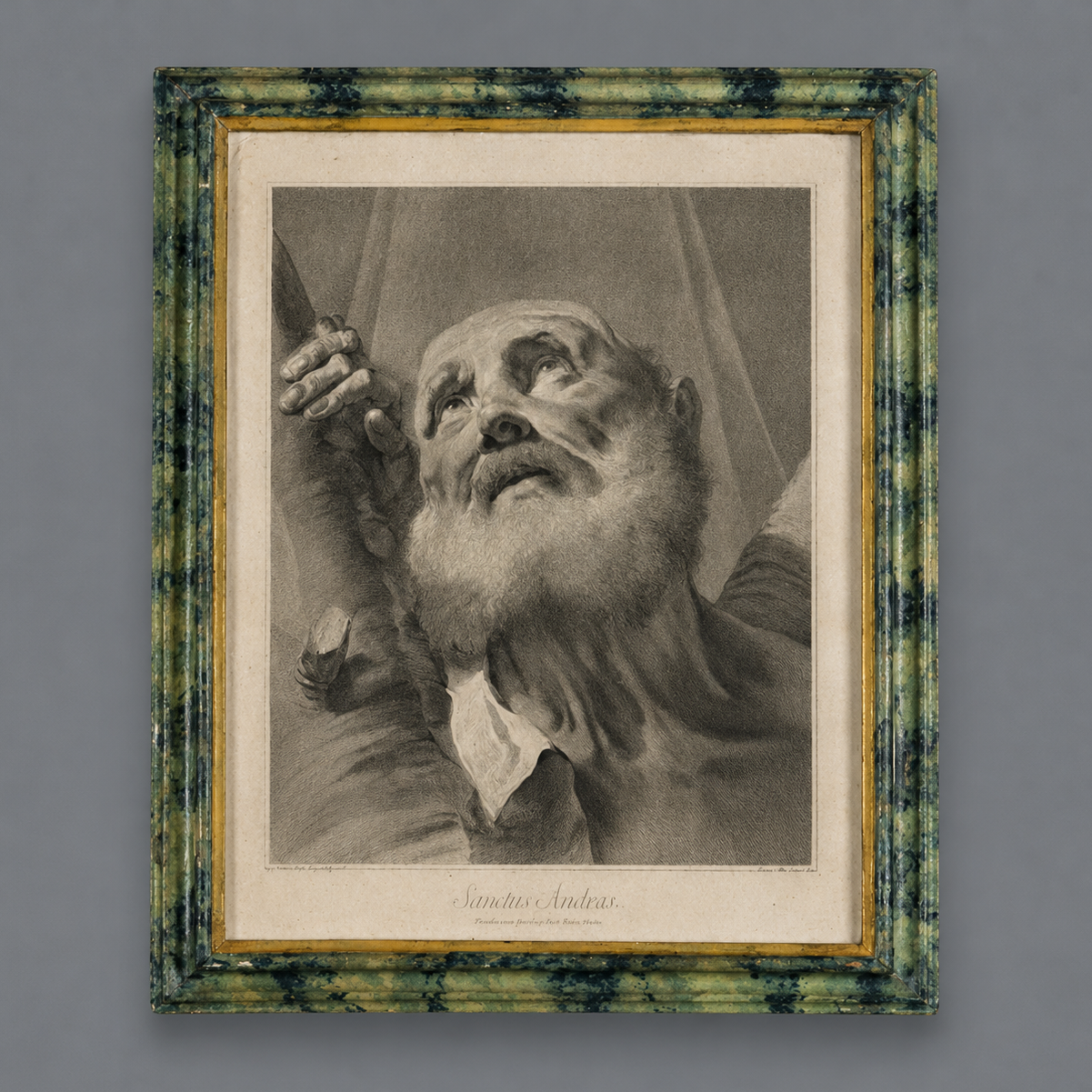 Framed antique engraving 'Sanctus Andreas' depicting Saint Andrew, black and white print in green marbled wood frame with gold inner border.