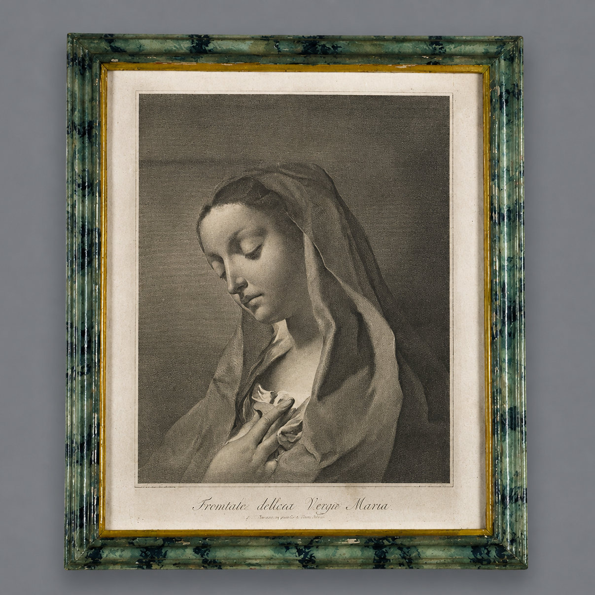 Antique religious engraving of the Virgin Mary in prayer, framed in a distressed green marbled wood frame with gold inner border, monochromatic print