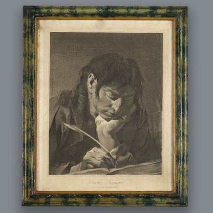 Antique framed engraving print depicting a young man writing with a quill pen, housed in a green marbled wood frame with gold inner border, monochrome tones.