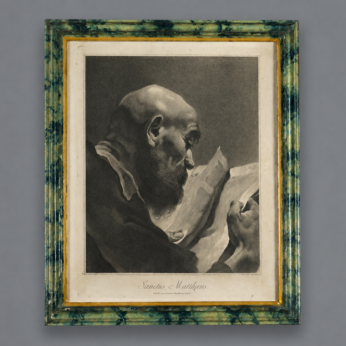 Framed engraving of Sanctus Matthaus depicting a bearded elderly man reading, in a green marbled frame with gold inner border, black and white print.