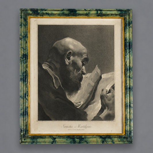 Framed engraving of Sanctus Matthaus depicting a bearded elderly man reading, in a green marbled frame with gold inner border, black and white print.