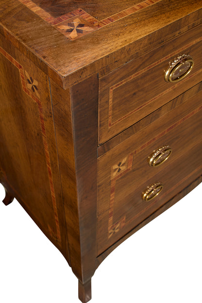 Brown wooden chest of drawers with decorative star inlay patterns, brass oval handles, and tapered legs. Features rich wood grain with contrasting light and dark wood borders.