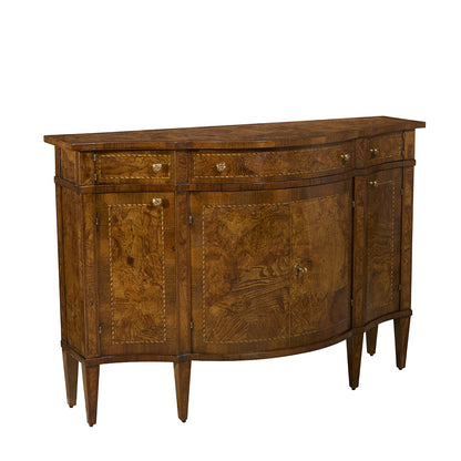 Traditional brown wood sideboard with curved front, featuring intricate burled wood veneer, three upper drawers and lower cabinet doors with brass hardware, standing on tapered legs