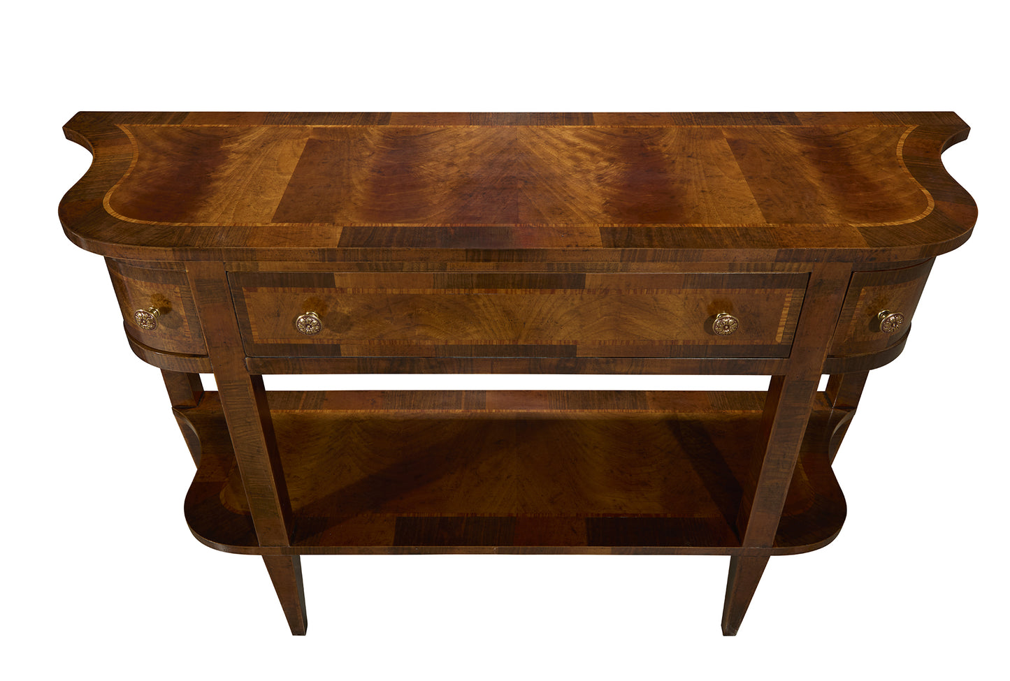 Traditional walnut console table with curved edges, brass drawer pulls, single center drawer, and lower shelf storage. Features rich wood grain patterns and elegant curved design.