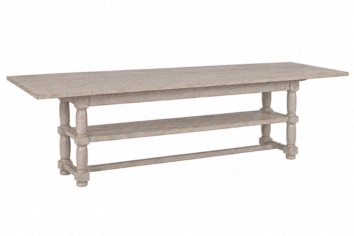 Farmhouse-style distressed gray wood console table with turned legs, lower shelf, and extension leaves, featuring a weathered whitewash finish and stretcher base.