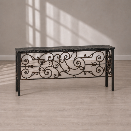Lodovico console table with ornate wrought iron scrollwork base in antique bronze and a dark black marble top with white veining, traditional style.