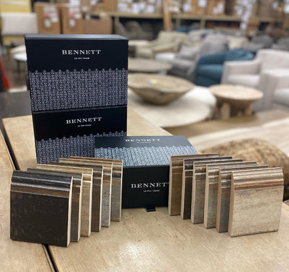 Wood finish sample squares in various brown tones from light oak to dark walnut, displayed with black Bennett branded boxes in warehouse setting