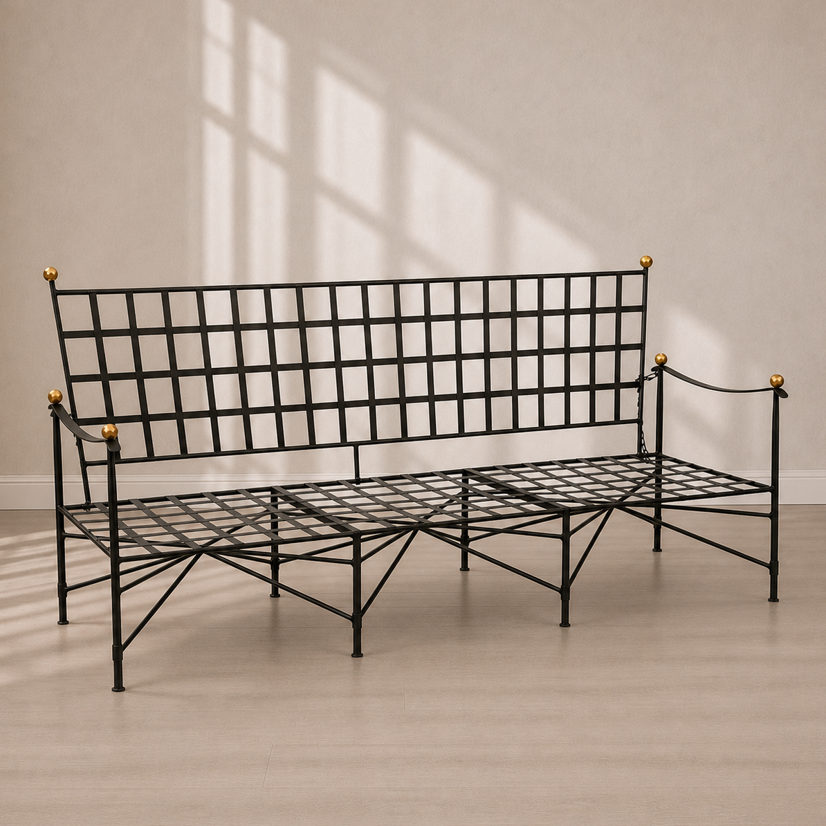 Black wrought iron garden bench with grid-pattern backrest and seat, decorative gold brass ball finials on corners, and crossed metal leg supports