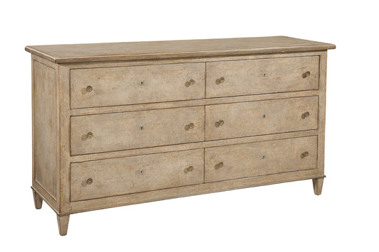 Traditional six-drawer dresser in weathered light brown wood finish with antique brass round knobs and keyhole details, featuring tapered legs and classic proportions