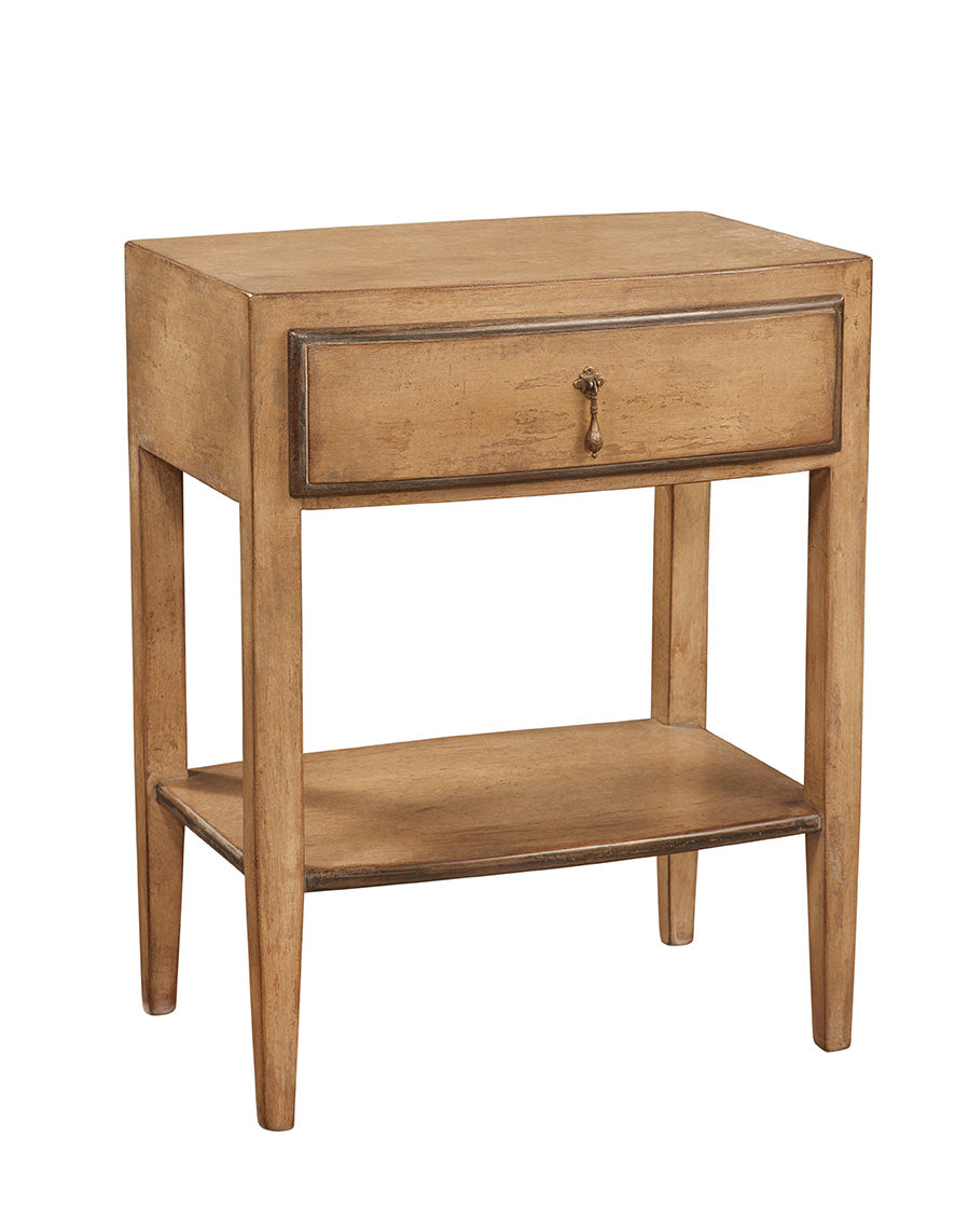 Natural wood occasional table with single drawer and lower shelf, featuring traditional styling with brass teardrop handle and tapered legs in warm honey-toned finish