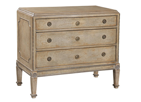 Three-drawer chest in weathered taupe finish with ornate brass circular hardware, featuring decorative carved legs, rope-style trim, and traditional neoclassical design elements