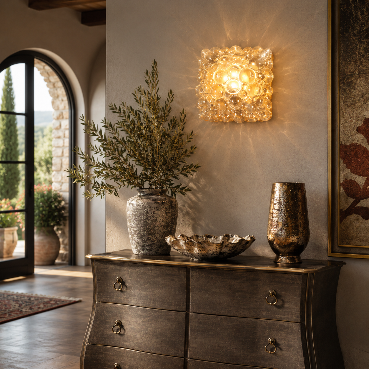 Square amber glass bubble wall sconce casting warm golden light patterns, featuring clustered glass orbs in a grid formation, mounted on a neutral plaster wall.