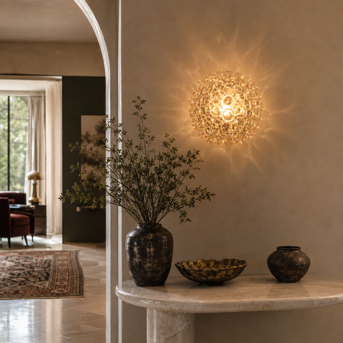 Glamorous crystal bubble wall sconce casting starburst shadow pattern on beige wall, globe-cluster design with warm amber glow, ornate decorative lighting fixture