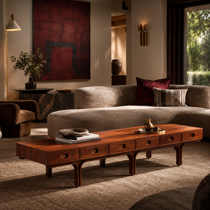 Mid-Century modern rectangular coffee table in rich walnut wood with circular drawer pulls, arched legs, and low-profile design, styled with books and decorative objects.