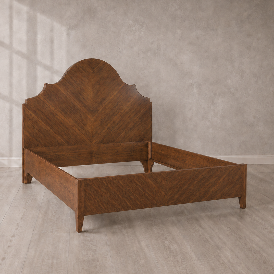 Walnut-toned wood bed frame with arched headboard featuring chevron parquet pattern, notched corners, tapered legs, and matching low footboard in warm brown finish.